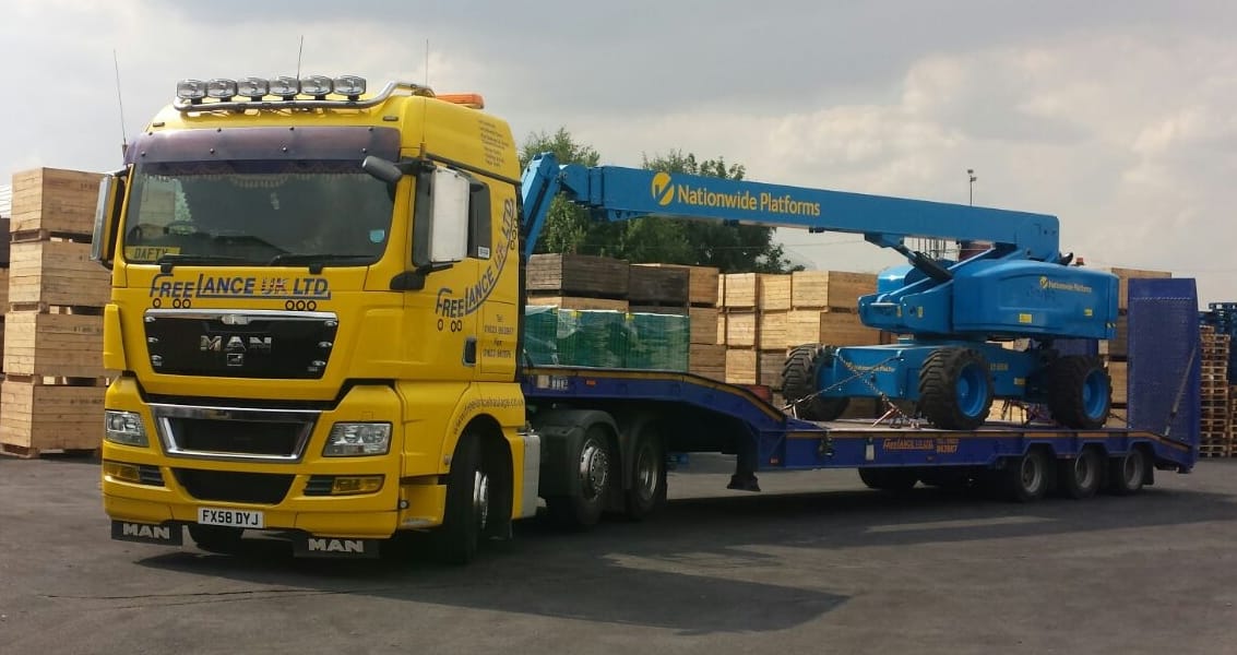 access equipment delivered by low loader truck
