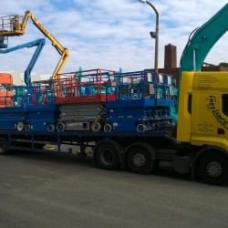 scissor lifts on low loader truck